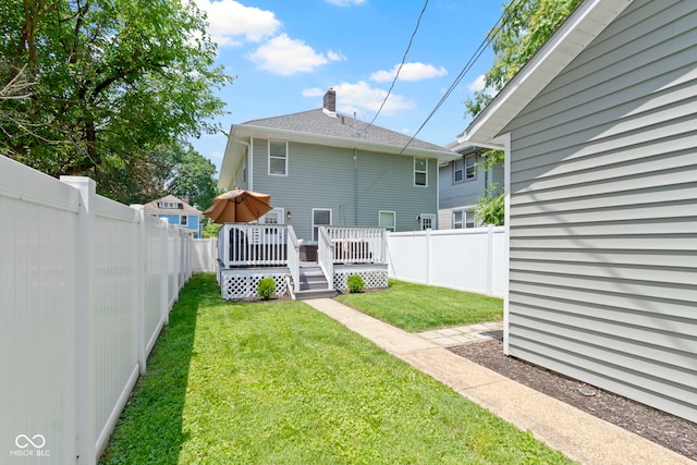 3045 Ruckle St, Indianapolis, IN 46205 - back of property with a wooden deck, a fenced backyard, and a chimney