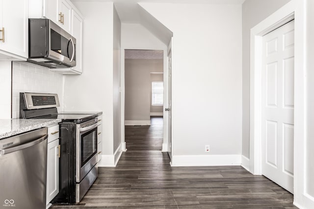 3045 Ruckle St, Indianapolis, IN 46205 - kitchen featuring stainless steel appliances, dark wood-style floors, decorative backsplash, light stone countertops, and white cabinets