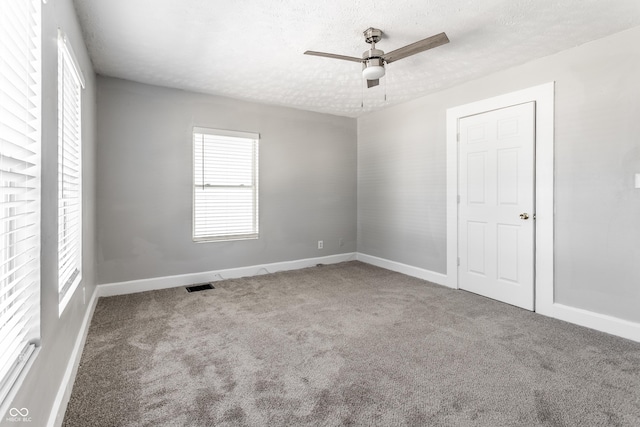 3045 Ruckle St, Indianapolis, IN 46205 - empty room with carpet flooring, a textured ceiling, and ceiling fan