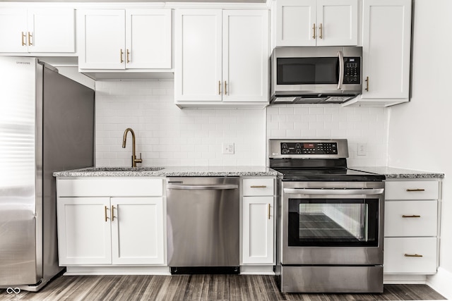 3045 Ruckle St, Indianapolis, IN 46205 - kitchen with stainless steel appliances, backsplash, light stone counters, and white cabinetry