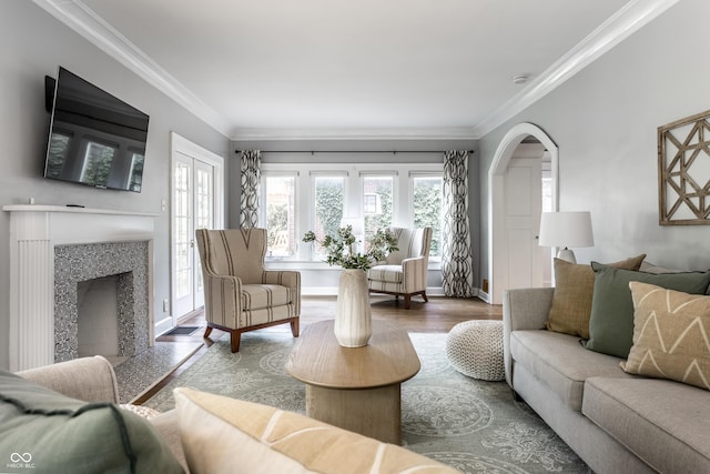 5760 Central Ave N, Indianapolis, IN 46220 - living room with healthy amount of natural light, wood finished floors, ornamental molding, arched walkways, and a fireplace