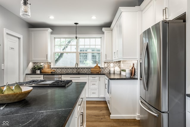5760 Central Ave N, Indianapolis, IN 46220 - kitchen featuring stainless steel appliances, white cabinets, dark wood-style flooring, decorative backsplash, and recessed lighting