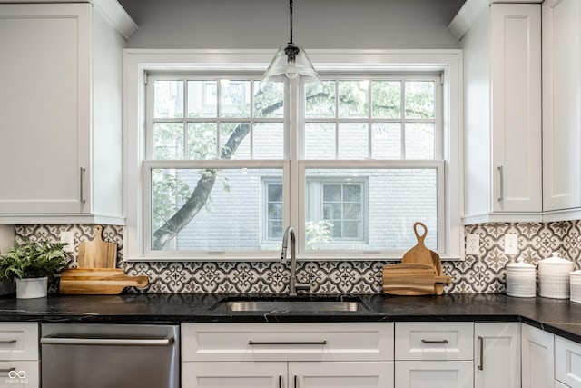 5760 Central Ave N, Indianapolis, IN 46220 - kitchen with stainless steel dishwasher, white cabinetry, decorative backsplash, and decorative light fixtures