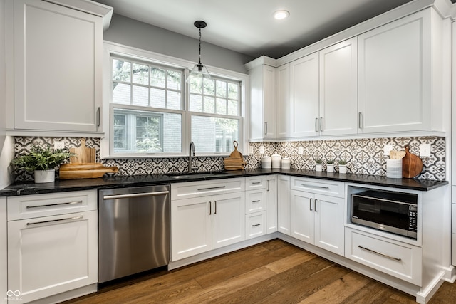 5760 Central Ave N, Indianapolis, IN 46220 - kitchen featuring appliances with stainless steel finishes, dark countertops, white cabinetry, dark wood-style flooring, and recessed lighting