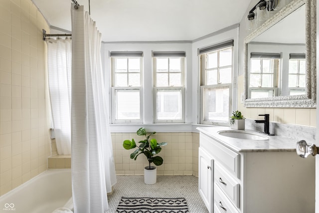 5760 Central Ave N, Indianapolis, IN 46220 - full bath featuring tile walls, shower / tub combo, vanity, and tile patterned floors
