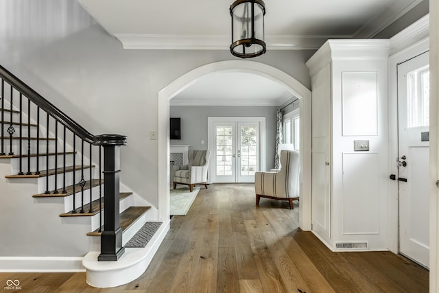 5760 Central Ave N, Indianapolis, IN 46220 - foyer featuring arched walkways, wood finished floors, french doors, stairway, and ornamental molding