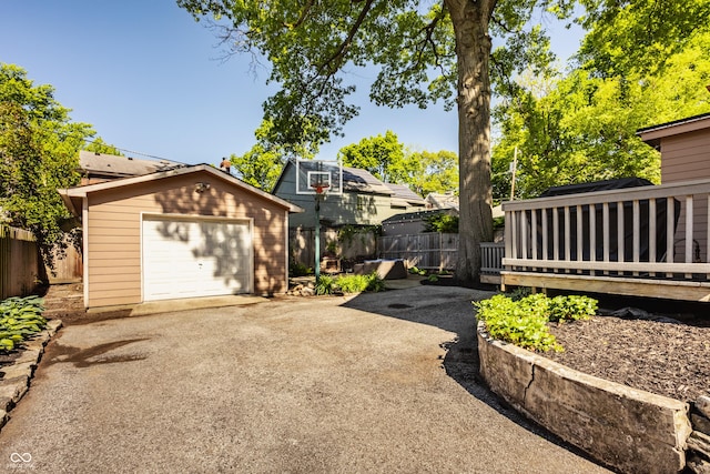 5760 Central Ave N, Indianapolis, IN 46220 - view of property exterior featuring driveway, an outdoor structure, a garage, and a deck