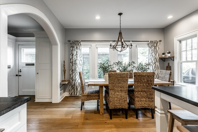 5760 Central Ave N, Indianapolis, IN 46220 - dining area with arched walkways, a chandelier, light wood-style floors, recessed lighting, and healthy amount of natural light
