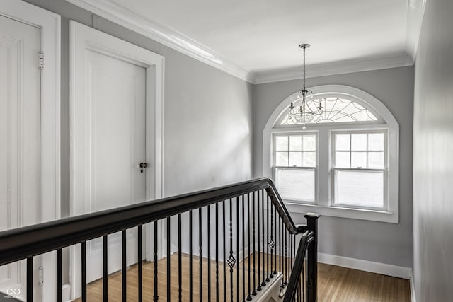5760 Central Ave N, Indianapolis, IN 46220 - staircase featuring wood finished floors, a chandelier, and ornamental molding