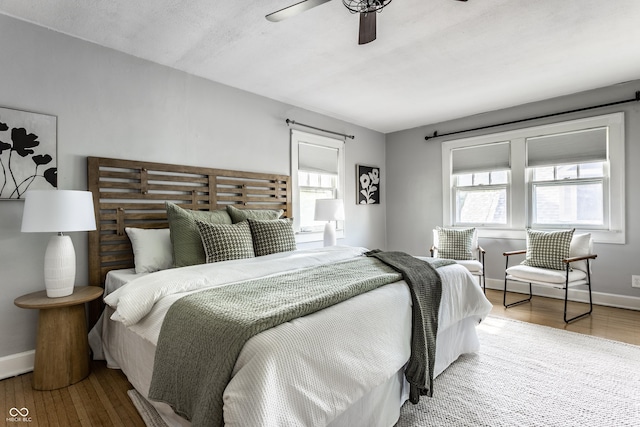 5760 Central Ave N, Indianapolis, IN 46220 - bedroom featuring multiple windows, wood finished floors, and a ceiling fan