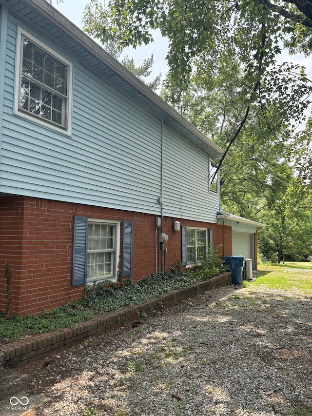 9011 Camby Rd, Camby, IN 46113 - view of home's exterior with a garage, brick siding, and driveway