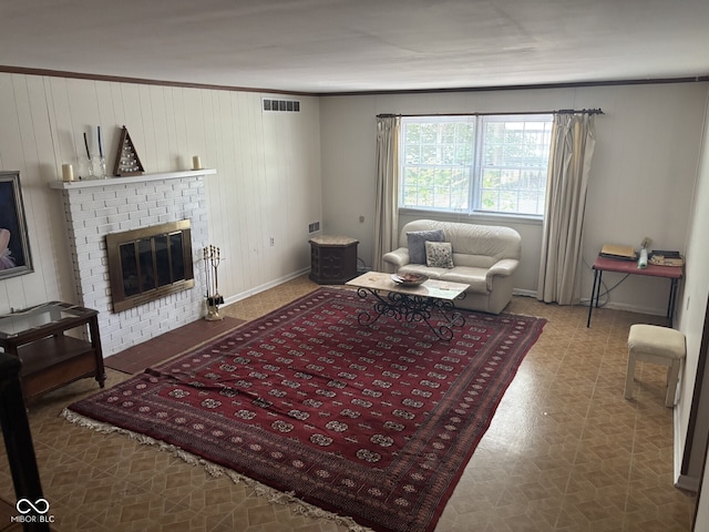 9011 Camby Rd, Camby, IN 46113 - living area featuring a fireplace, wood walls, tile patterned floors, and crown molding