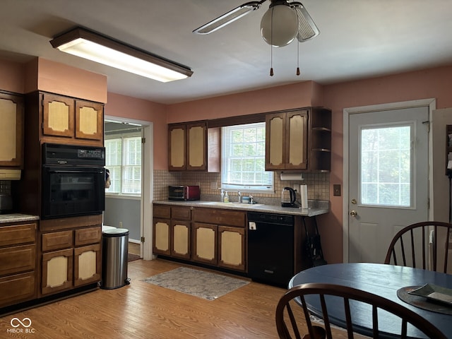 9011 Camby Rd, Camby, IN 46113 - kitchen with black appliances, light countertops, tasteful backsplash, and light wood finished floors