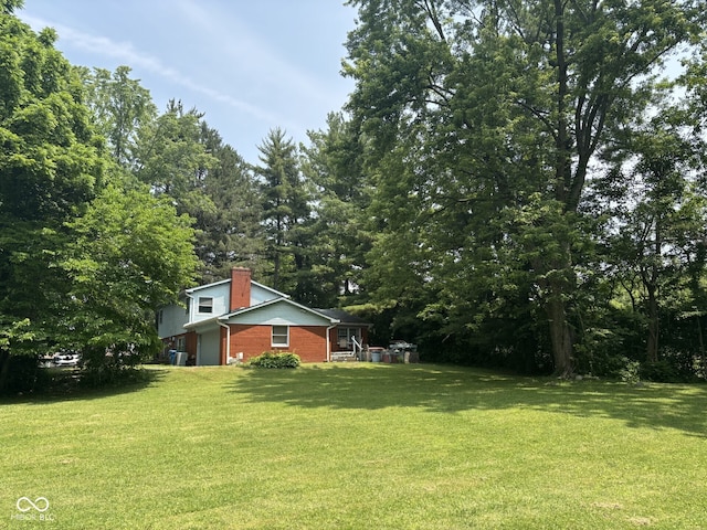 9011 Camby Rd, Camby, IN 46113 - view of grassy yard featuring an attached garage