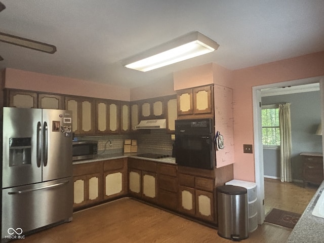 9011 Camby Rd, Camby, IN 46113 - kitchen featuring black appliances, under cabinet range hood, wood finished floors, decorative backsplash, and light countertops
