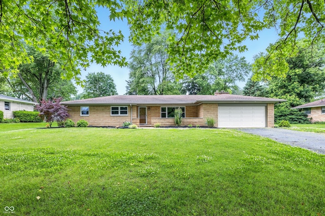 5205 Staughton Dr, Indianapolis, IN 46226 - ranch-style house with an attached garage, driveway, a front yard, a chimney, and brick siding
