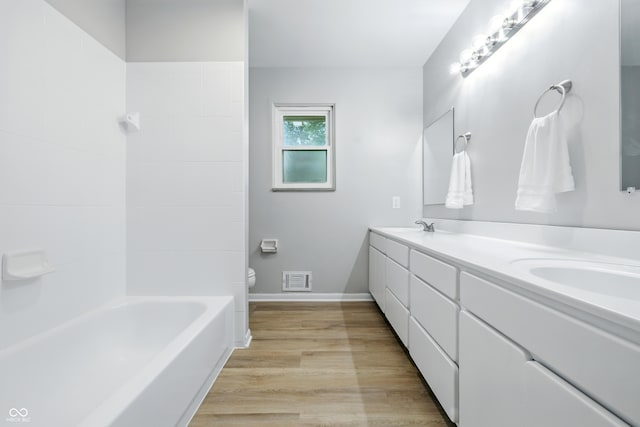 5205 Staughton Dr, Indianapolis, IN 46226 - full bath with double vanity, wood finished floors, and shower / bathtub combination