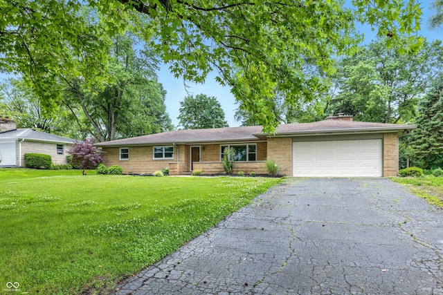 5205 Staughton Dr, Indianapolis, IN 46226 - single story home featuring a garage, a front lawn, driveway, a chimney, and brick siding