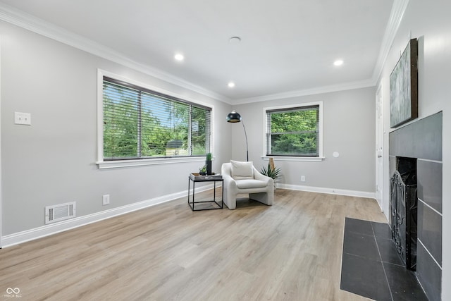 5205 Staughton Dr, Indianapolis, IN 46226 - sitting room with a fireplace with flush hearth, crown molding, light wood-style floors, and recessed lighting