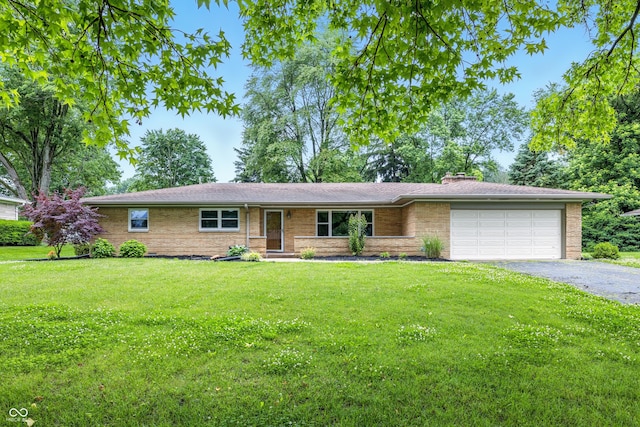 5205 Staughton Dr, Indianapolis, IN 46226 - single story home with an attached garage, asphalt driveway, a front yard, a chimney, and brick siding