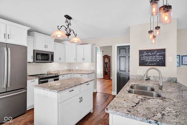 2384 Fairfax Dr, Columbus, IN 47203 - kitchen featuring stainless steel appliances, dark wood-type flooring, light stone counters, and white cabinetry