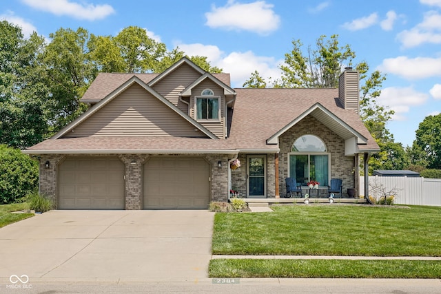 2384 Fairfax Dr, Columbus, IN 47203 - view of front of home with a garage, roof with shingles, driveway, brick siding, and a chimney