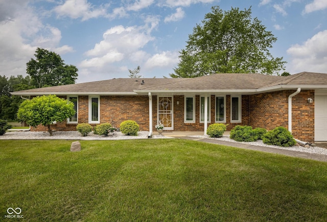 5749 Teresa Dr, Alexandria, IN 46001 - ranch-style house with brick siding, a front yard, and a garage