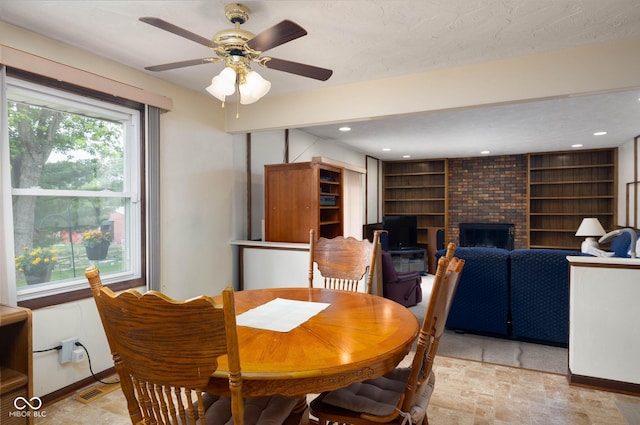 5749 Teresa Dr, Alexandria, IN 46001 - dining space with a brick fireplace, ceiling fan, and recessed lighting