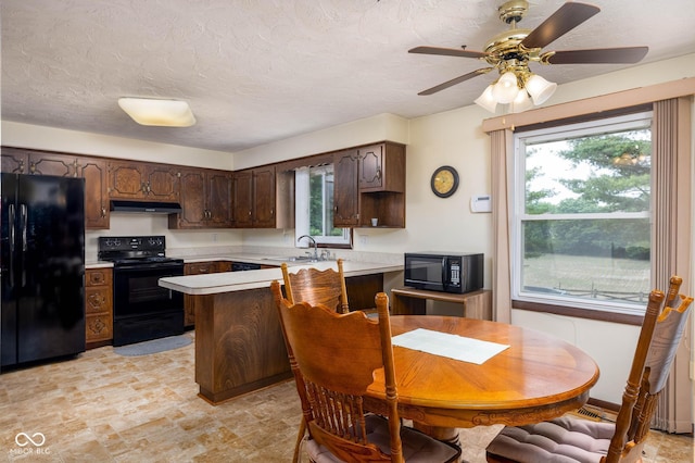 5749 Teresa Dr, Alexandria, IN 46001 - kitchen featuring black appliances, light countertops, a peninsula, dark brown cabinetry, and healthy amount of natural light