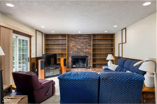 5749 Teresa Dr, Alexandria, IN 46001 - living room featuring recessed lighting, carpet floors, a textured ceiling, a fireplace, and built in features