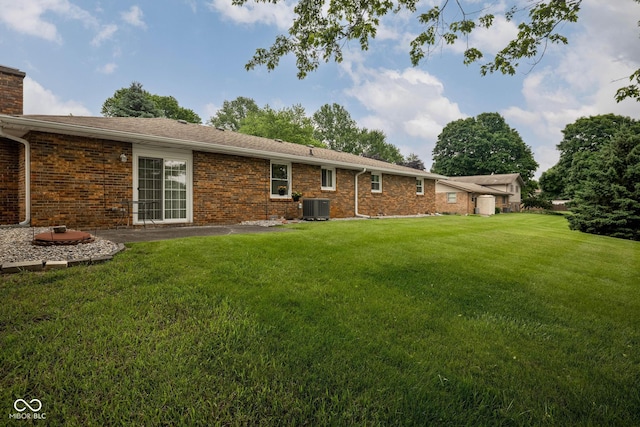 5749 Teresa Dr, Alexandria, IN 46001 - rear view of property featuring a yard, brick siding, and a chimney