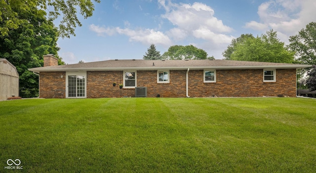 5749 Teresa Dr, Alexandria, IN 46001 - back of property with a chimney, a lawn, and brick siding
