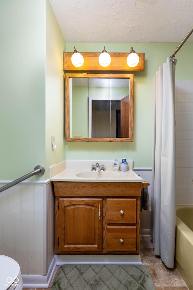 5749 Teresa Dr, Alexandria, IN 46001 - full bathroom with vanity, wainscoting, and shower / tub combo