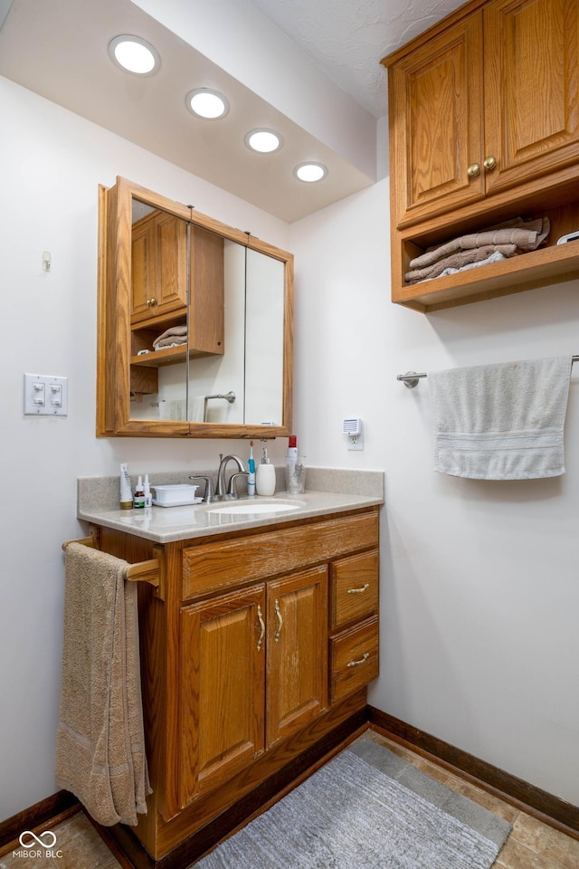 5749 Teresa Dr, Alexandria, IN 46001 - kitchen with brown cabinetry, recessed lighting, and light countertops
