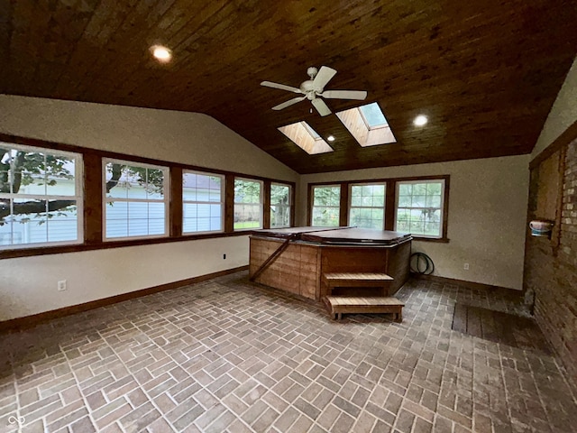 7721 Hollybrook Ln, Indianapolis, IN 46227 - sunroom featuring a hot tub, vaulted ceiling, a skylight, and healthy amount of natural light