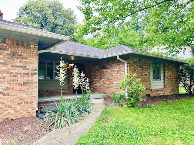 7721 Hollybrook Ln, Indianapolis, IN 46227 - entrance to property featuring brick siding, a yard, a porch, and a shingled roof