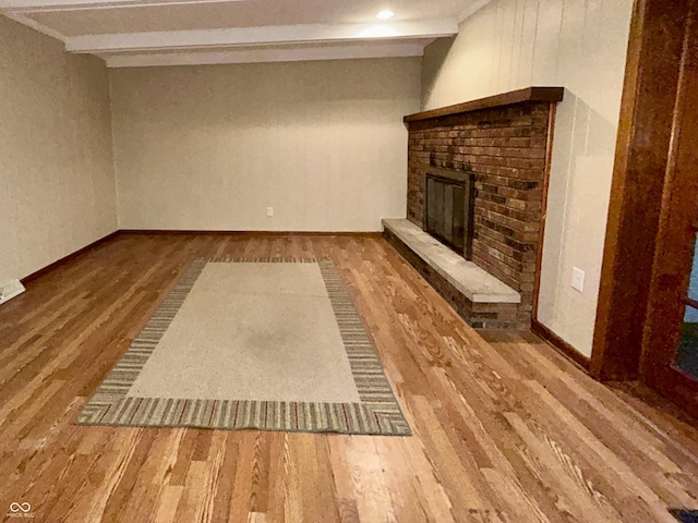 7721 Hollybrook Ln, Indianapolis, IN 46227 - unfurnished living room featuring wood finished floors and a fireplace