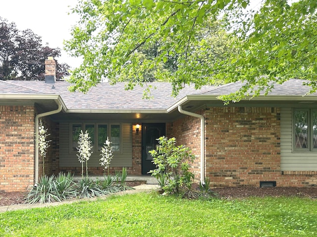 7721 Hollybrook Ln, Indianapolis, IN 46227 - property entrance with a lawn, a shingled roof, a chimney, and brick siding