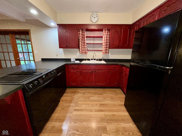 7721 Hollybrook Ln, Indianapolis, IN 46227 - kitchen featuring black appliances, light wood-type flooring, dark brown cabinets, dark countertops, and recessed lighting
