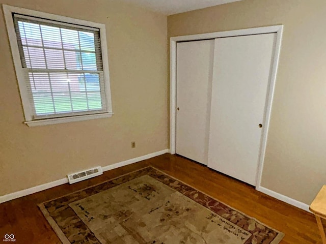 7721 Hollybrook Ln, Indianapolis, IN 46227 - unfurnished bedroom with wood finished floors and a closet