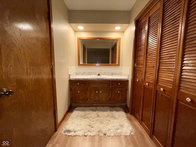 7721 Hollybrook Ln, Indianapolis, IN 46227 - bathroom featuring a closet, vanity, and wood finished floors
