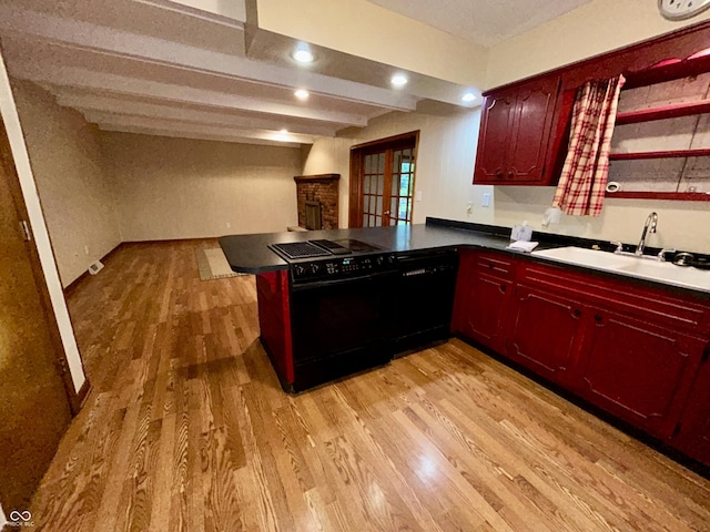 7721 Hollybrook Ln, Indianapolis, IN 46227 - kitchen with black appliances, light wood finished floors, a peninsula, dark brown cabinets, and dark countertops
