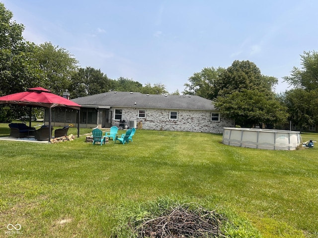 2213 Holden Dr, Anderson, IN 46012 - back of house featuring a lawn, an outdoor pool, and outdoor lounge area