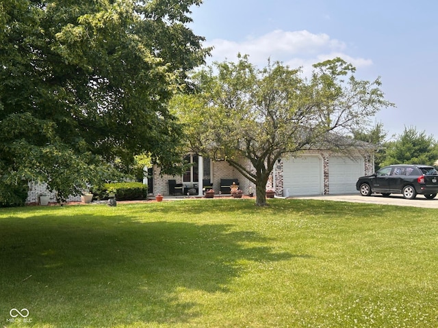 2213 Holden Dr, Anderson, IN 46012 - obstructed view of property featuring driveway, a front lawn, a garage, and brick siding