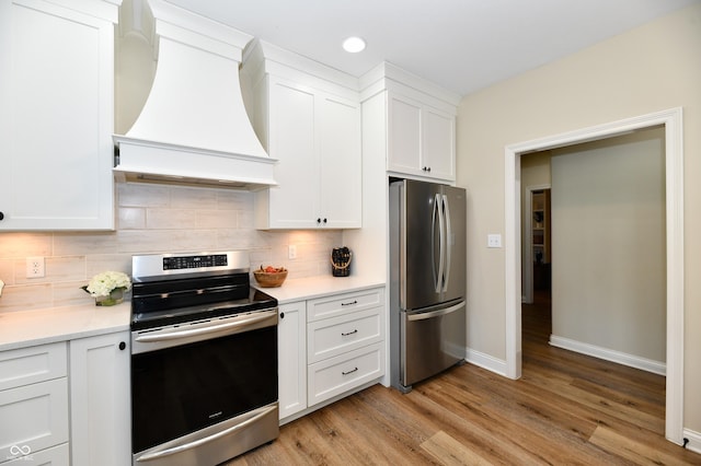 7413 Misty Woods Ln, Indianapolis, IN 46237 - kitchen with appliances with stainless steel finishes, custom range hood, light countertops, white cabinets, and backsplash