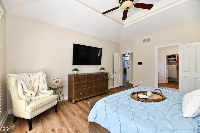 7413 Misty Woods Ln, Indianapolis, IN 46237 - bedroom with wood finished floors, a raised ceiling, ceiling fan, and a walk in closet