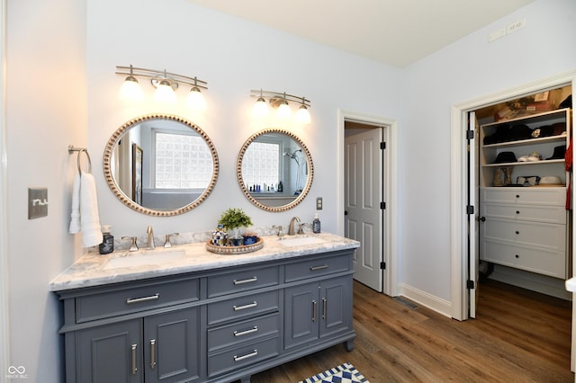 7413 Misty Woods Ln, Indianapolis, IN 46237 - full bathroom with wood finished floors, double vanity, and a walk in closet
