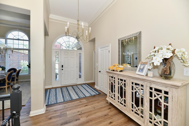 7413 Misty Woods Ln, Indianapolis, IN 46237 - entryway featuring a chandelier, ornamental molding, a high ceiling, and wood finished floors