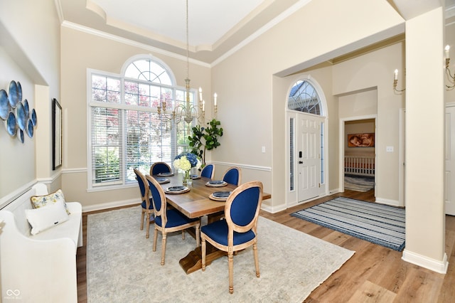 7413 Misty Woods Ln, Indianapolis, IN 46237 - dining space with plenty of natural light, wood finished floors, a towering ceiling, ornamental molding, and a chandelier