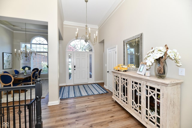 7413 Misty Woods Ln, Indianapolis, IN 46237 - entrance foyer featuring a chandelier, crown molding, wood finished floors, and a towering ceiling